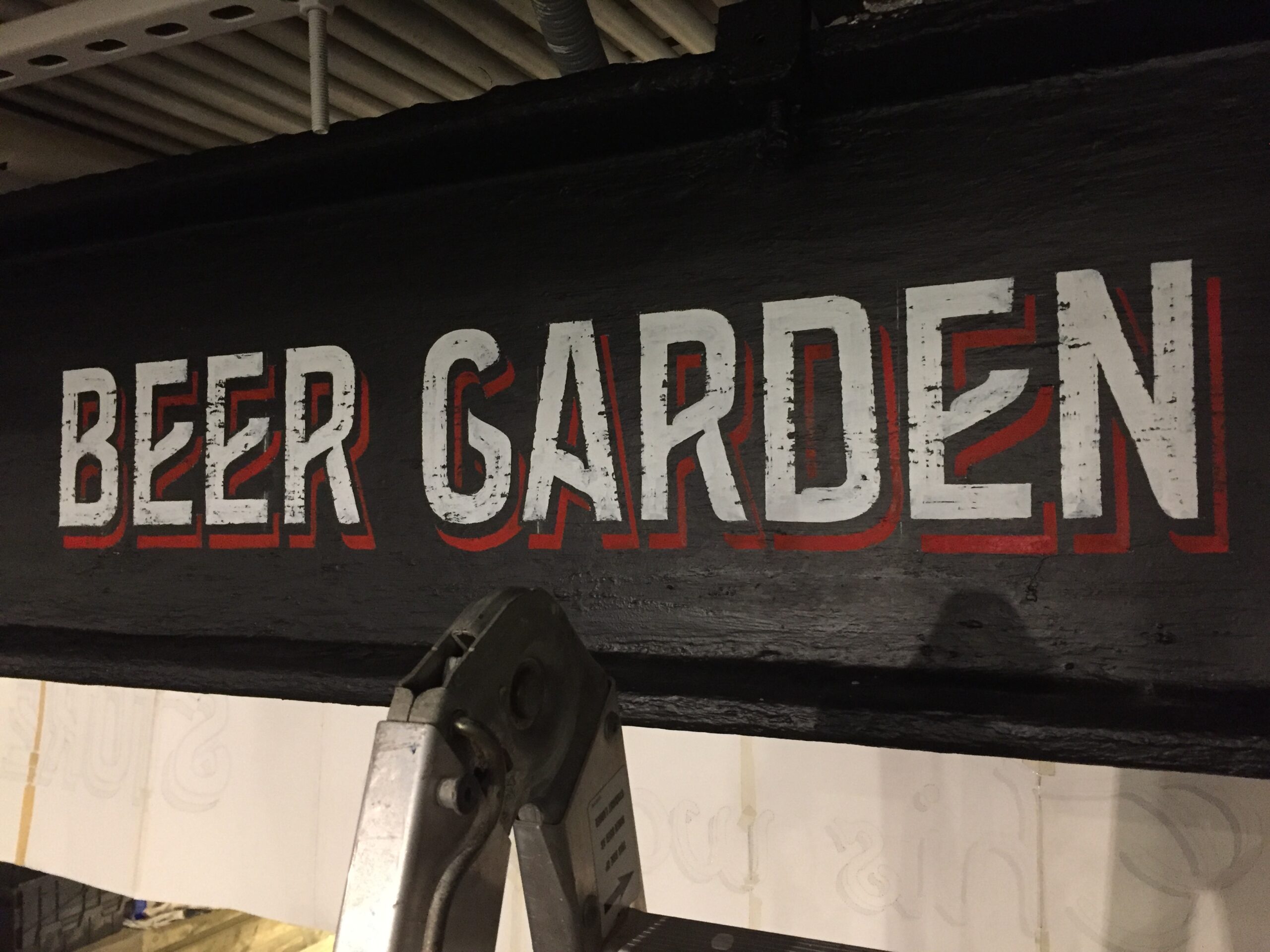 The text Beer Garden in white on a black background with a red shadow